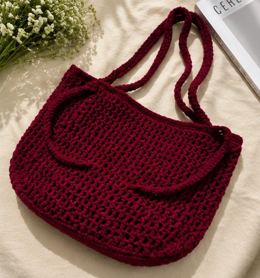 Handmade burgundy crochet shoulder bag with minimalist woven design for everyday use.