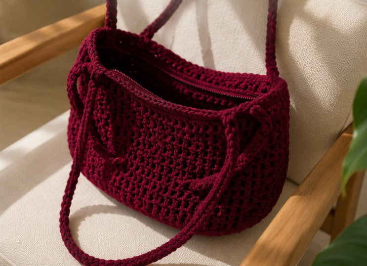 Handmade burgundy crochet shoulder bag with minimalist woven design for everyday use.